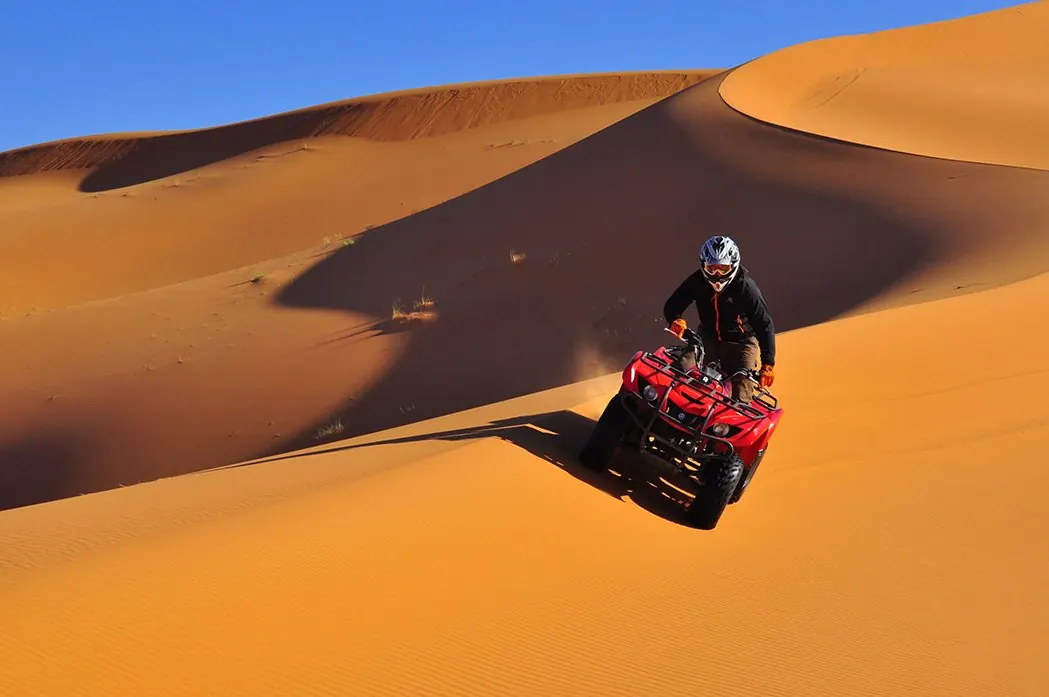 Quad bike on a dune near the camp